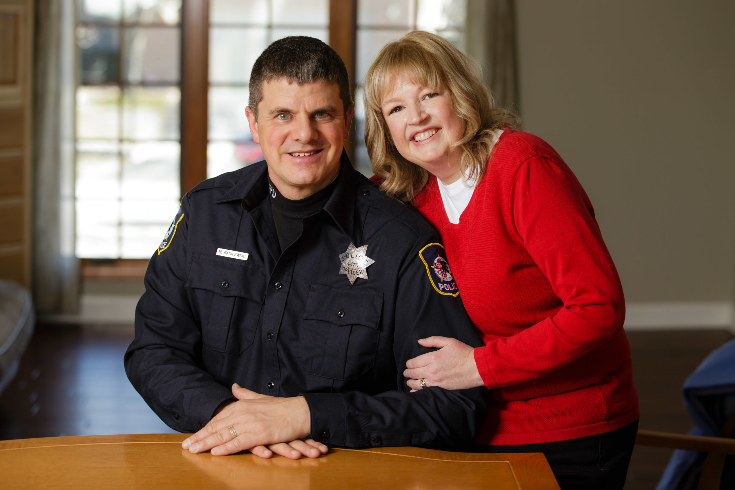 Police officer and person smiling together